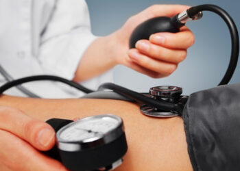 Unrecognizable physician measures blood pressure a patient, close-up