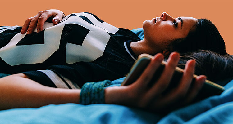 Young woman feeling worried after checking COVID-19 symptoms online and staying home for safety